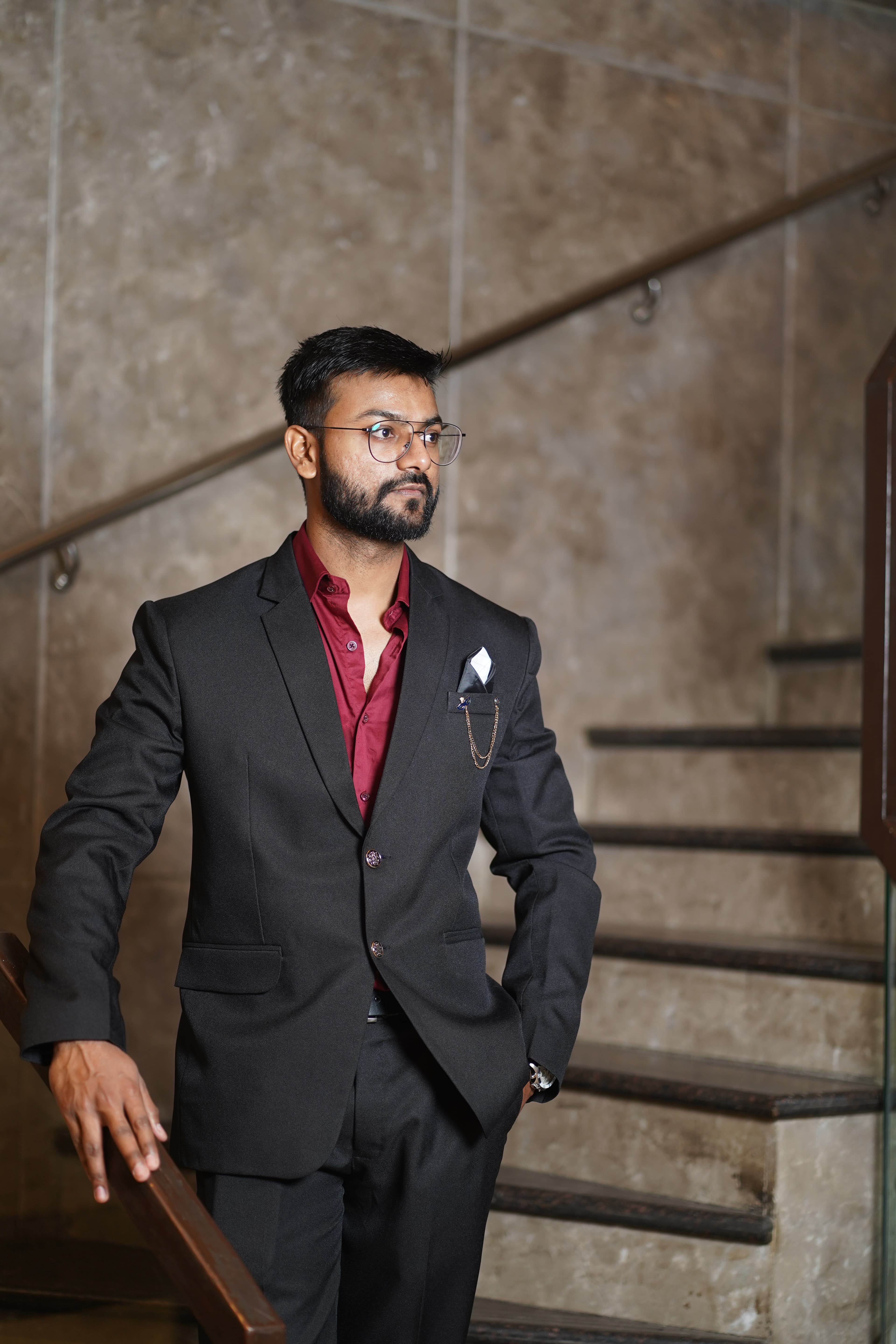 Candid portrait leaning on a wooden banister in a hotel lobby